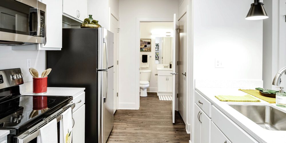 Kitchen and entrance to bathroom in one bedroom unit at The Arno apartments