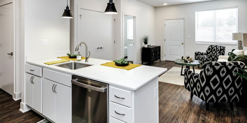 Looking over kitchen counter to living room in one bedroom unit at The Arno apartments